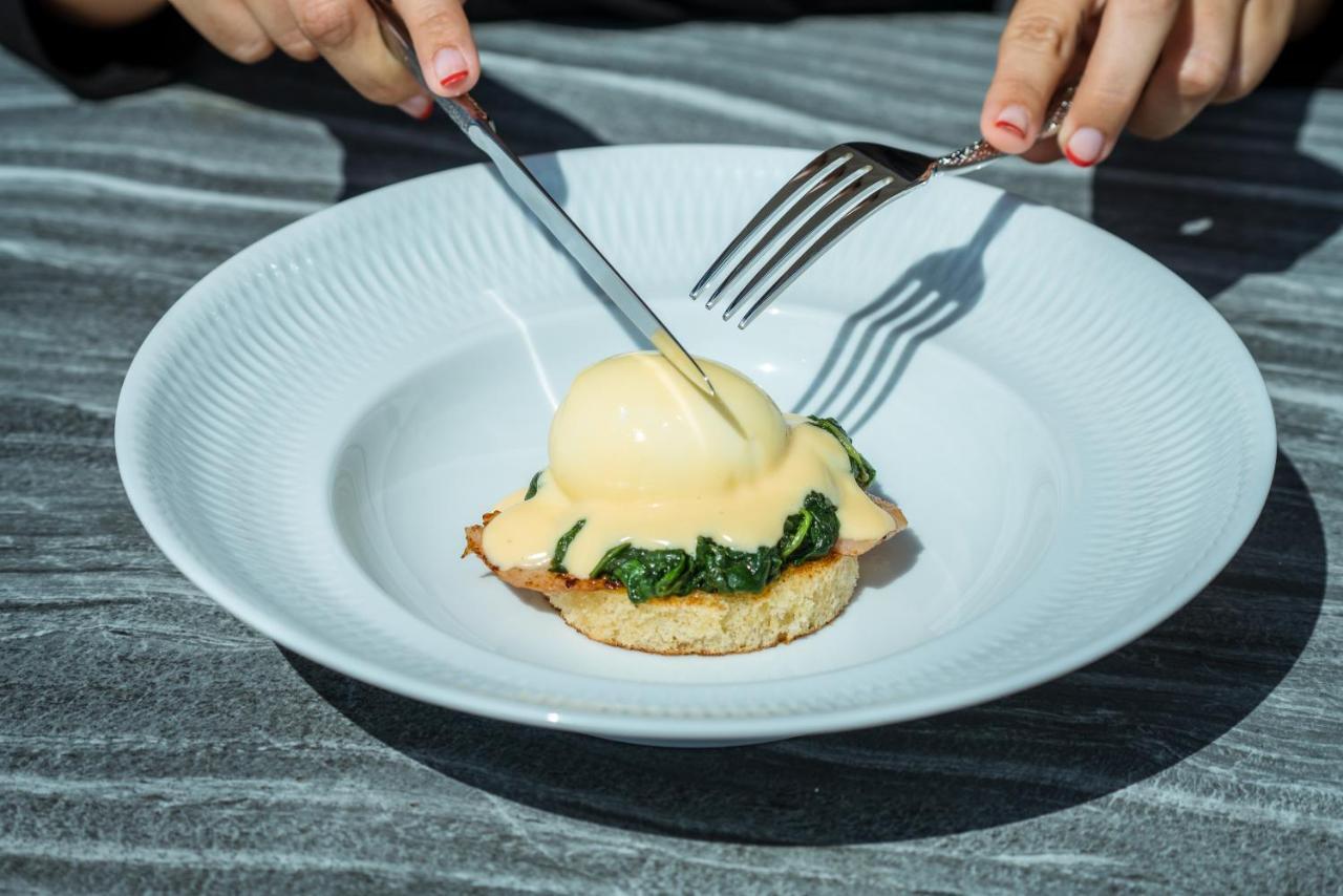 El Llorenc Parc De La Mar - Adults Only Palma de Mallorca Exteriör bild A poached egg being cut with a knife and fork